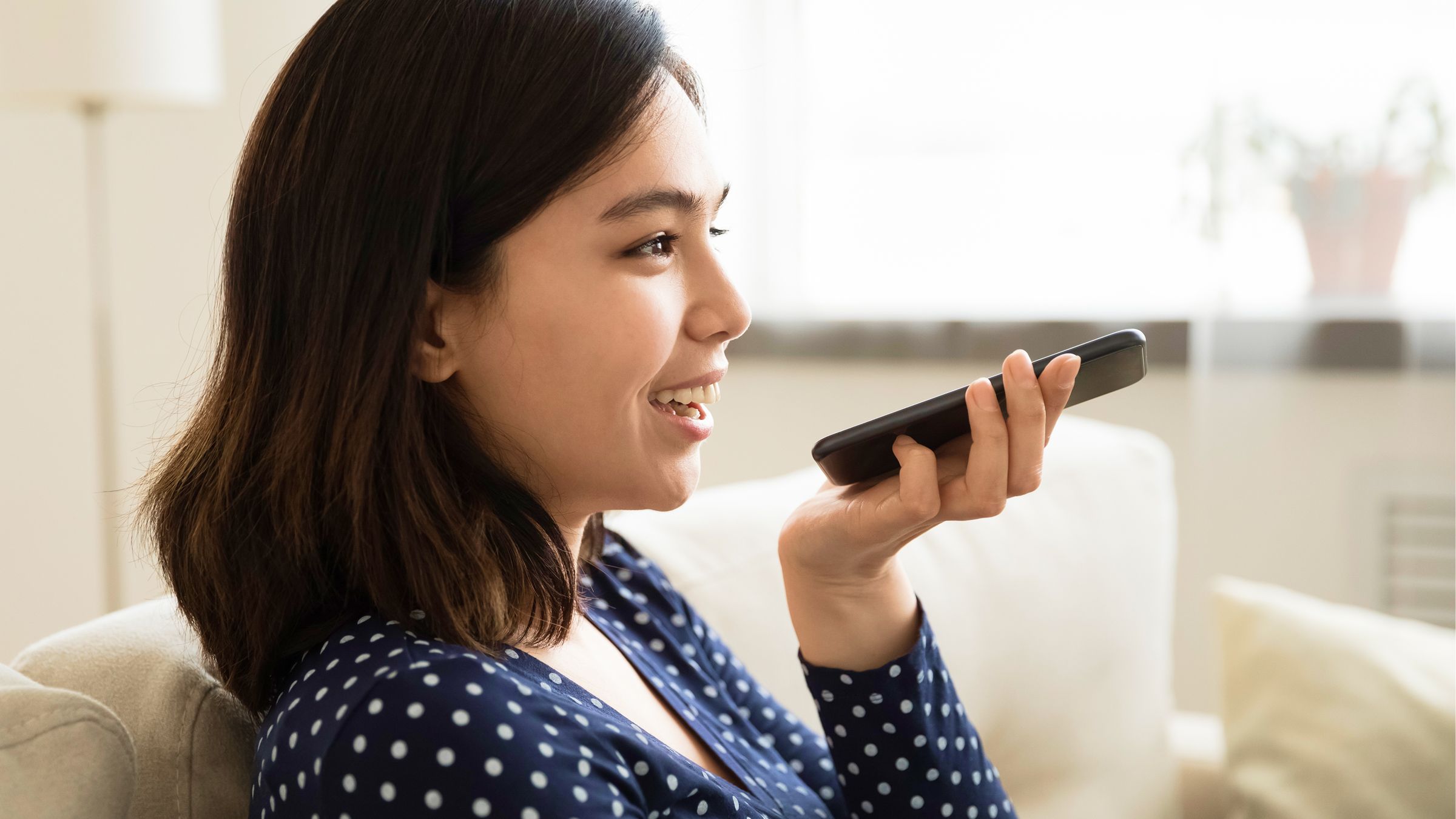 Student practising spoken English using a voice agent on her phone